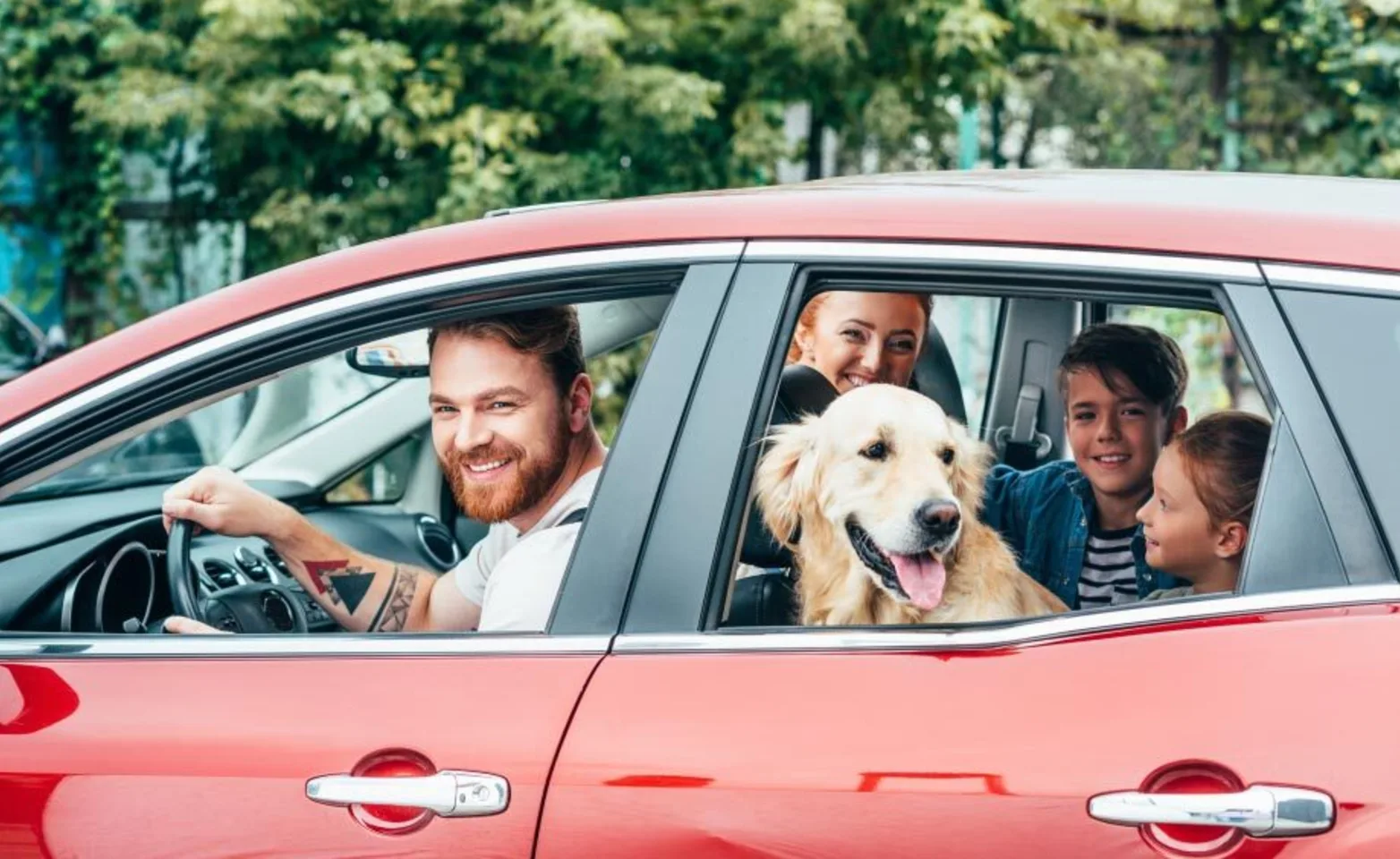 Family in car with a dog